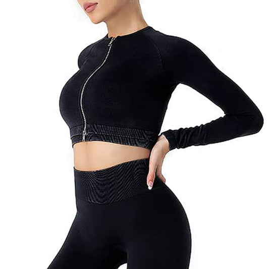 A person wearing a black long-sleeve zip-up crop top and high-waisted black leggings poses against a white background. The Fusion Seamless Workout Tracksuit combines high-performance fashion with flexible & breathable fabric for a fitted and sleek activewear design.