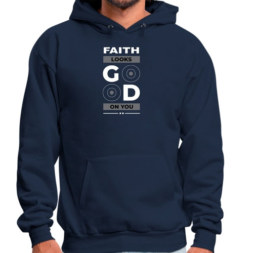 A person is wearing a navy blue Faith Looks Good Graphic Hoodie with the text "FAITH LOOKS GOOD ON YOU" printed on the front. The word "GOOD" is stylized with two letters "O" resembling vinyl records. The person's hands are visible, resting casually by their sides.