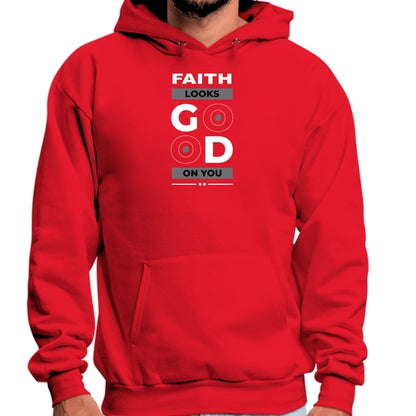 A person wearing a red Faith Looks Good Graphic Hoodie with the words "FAITH LOOKS GOOD ON YOU" printed on the front. The word "GOOD" has stylized "O" characters resembling eyes, creating a playful design. The Faith Looks Good Graphic Hoodie exudes positivity as the person stands against a plain background.