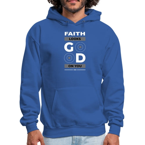 A person wearing a blue Faith Looks Good Graphic Hoodie with a text design on the front that reads, "FAITH LOOKS GOOD ON YOU" in bold white and gray letters with two target-like circles inside the "O"s of "GOOD." The graphic hoodie features a front pocket and a drawstring hood.