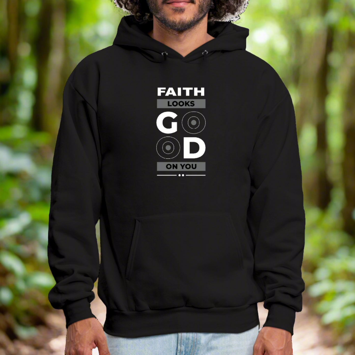 A person is wearing a black Faith Looks Good Graphic Hoodie with a front pocket. The graphic hoodie features a white text design that reads "Faith looks good on you," with the letters "GO" emphasized in a larger font and two circular symbols inside the "O"s, showcasing PeaLoha's unique style.